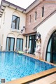 A woman standing on the edge of a swimming pool.