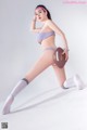 A woman in a bikini holding a football.