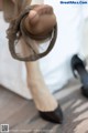 A close up of a woman's feet wearing black shoes.