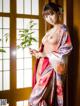 A woman in a kimono is posing for the camera.