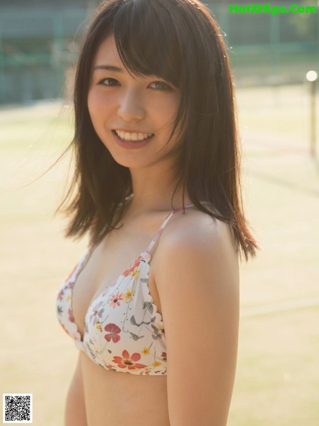 A woman in a bikini posing for a picture.